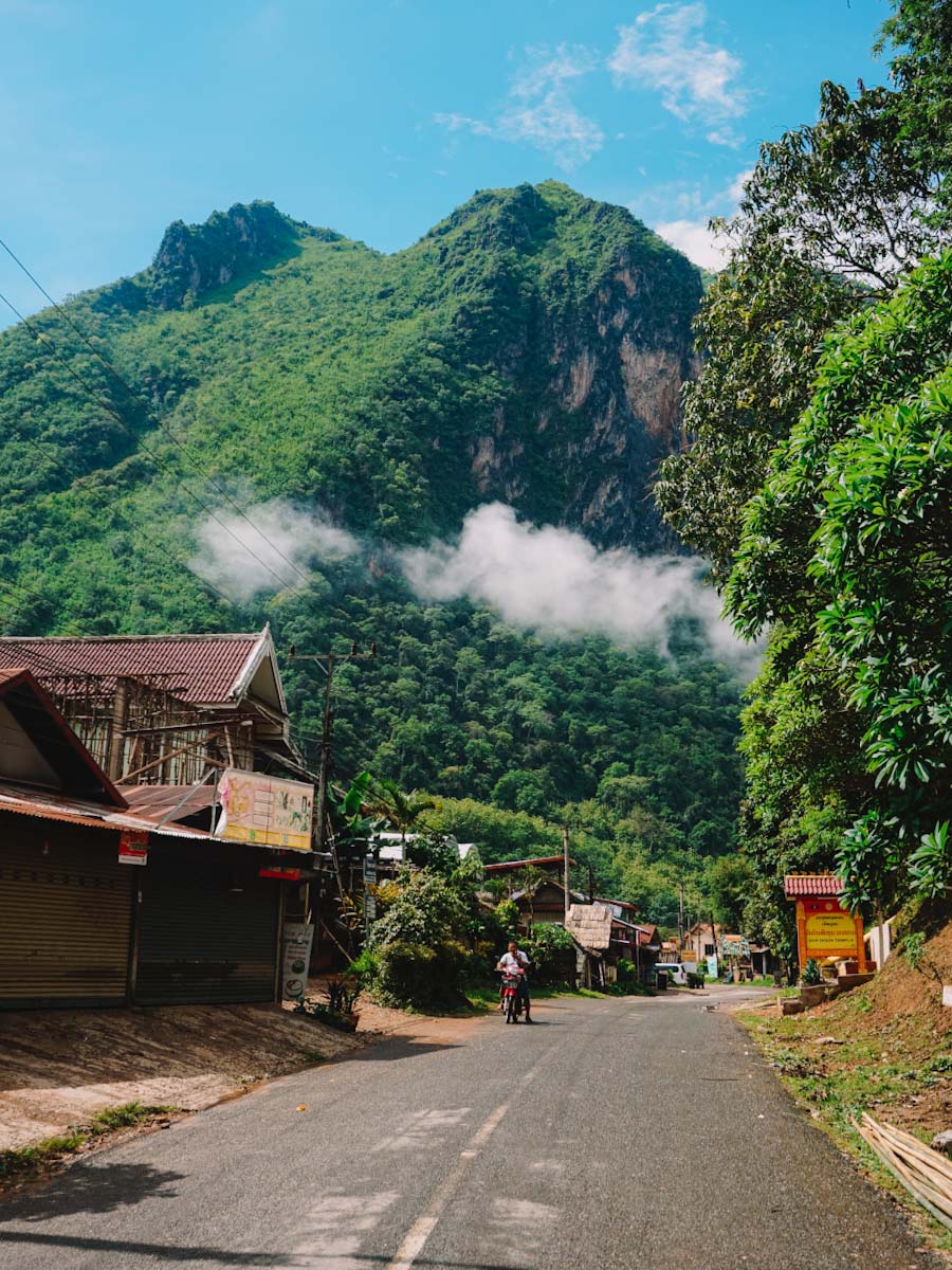 Street in Nong Khiaw with mountain backdrop