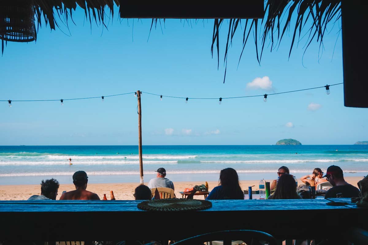 Watching people surf from beach bar at Duli Beach, El Nido