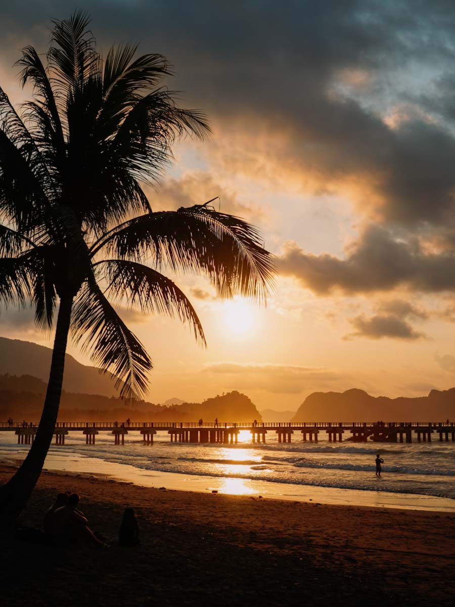 Lio beach during sunset with view of palmtree and jetty